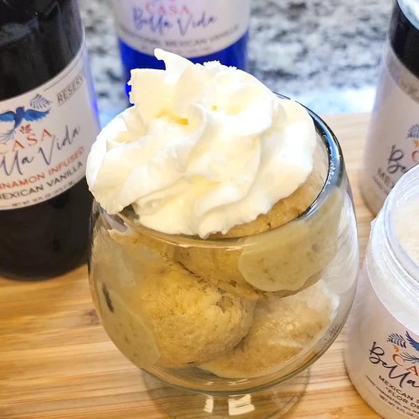 Bowl of Boozy Rum Raisin ice cream with whipped cream on top.